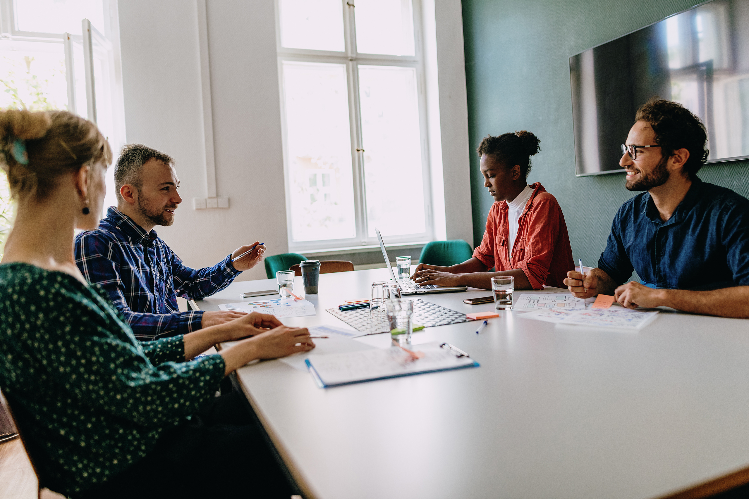 Business meeting with multi-ethnic business people A professional, creative team discusses strategic branding solutions for financial services marketing clients