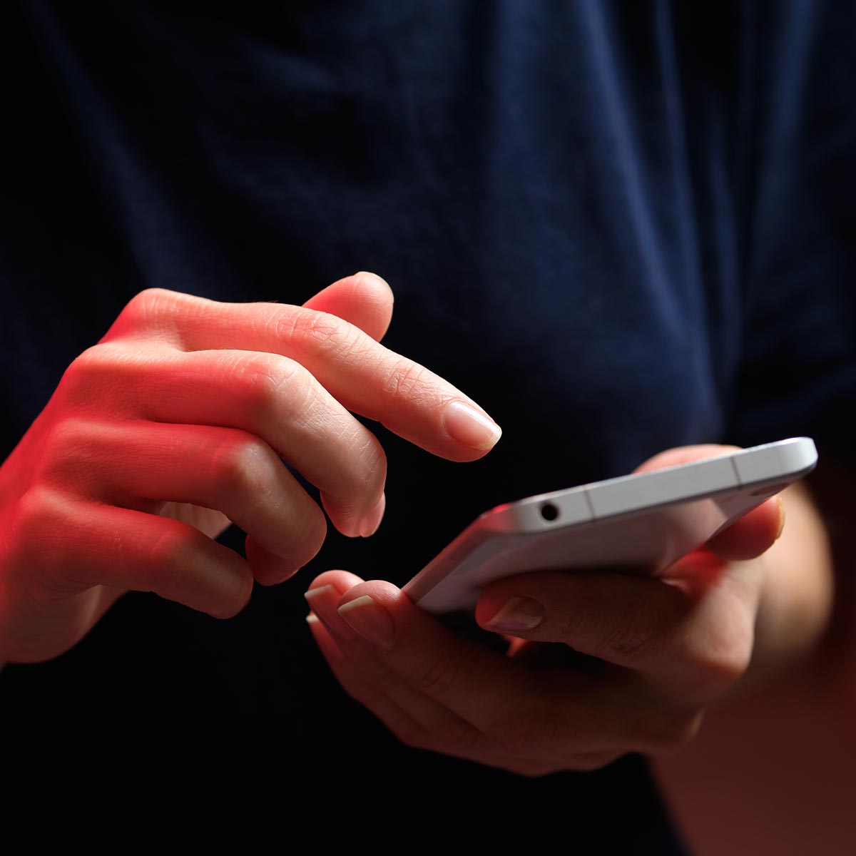 Person holding phone and scrolling through social media